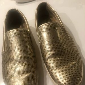 Michael Kohrs gold slip on sneaker
